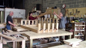 Woodworkers constructing a porch swing