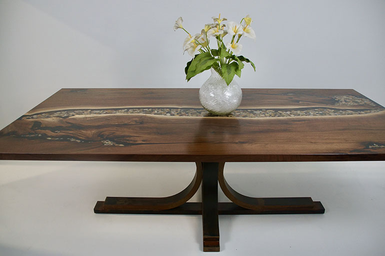 Buy A Live Edge Black Walnut Dining Table With A Table Top That Features A Clear Epoxy River With Embedded River Rocks $6,500+ [Send CVCF Your Stones] | For Sale At The CVCF River Table Online Store